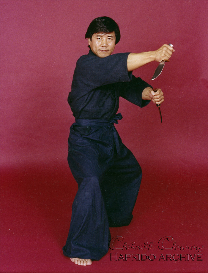 Chang poses with two daggers